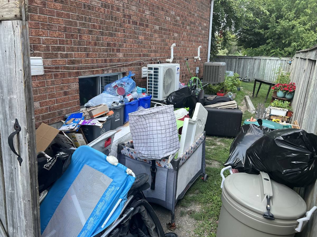 Sorted household items prepared for removal at a Kingston job site
